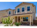 Inviting two-story home featuring a covered porch, desert landscaping, and a neutral color scheme at 4283 W Nora Dr, San Tan Valley, AZ 85144