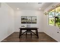 Bright and airy office space with wood-look floors and a large window at 4283 W Nora Dr, San Tan Valley, AZ 85144