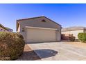 Charming one-story home with desert landscaping and a two-car garage with a large driveway at 45722 W Sky Ln, Maricopa, AZ 85139