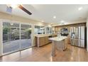 Updated kitchen with stainless steel appliances, granite countertops, and a center island open to a sunny patio at 5111 N 83Rd St, Scottsdale, AZ 85250