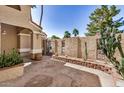Charming courtyard with stone pavers, stucco walls, wrought iron accents and desert plants at 529 E Taro Ln, Phoenix, AZ 85024