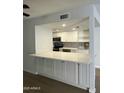 Modern kitchen features white cabinets, quartz countertops, stainless appliances, and tile backsplash at 540 E Royal Palms Dr, Mesa, AZ 85203