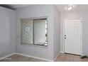 Cozy entryway with large window and a white front door at 6504 W Cochise Dr, Glendale, AZ 85302