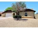 Charming single-story home with brick exterior, attached garage, and mature landscaping at 6504 W Cochise Dr, Glendale, AZ 85302