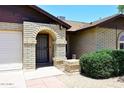Charming front entrance features brickwork and an arched doorway at 6504 W Cochise Dr, Glendale, AZ 85302