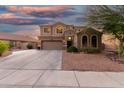 Attractive Southwestern home with arched windows, desert landscaping, and a two-car garage at 654 E Taylor Trl, San Tan Valley, AZ 85143