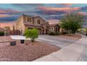 Beautiful two-story home with a three-car garage, long driveway, and desert landscaping at 654 E Taylor Trl, San Tan Valley, AZ 85143