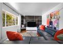 Bright living room featuring a modern blue sectional, art, and large window with natural light, creating a cozy atmosphere at 6906 E 4Th St # 4, Scottsdale, AZ 85251
