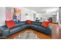 Spacious living room with a blue sectional, colorful artwork, and an open layout, creating a stylish and functional area at 6906 E 4Th St # 4, Scottsdale, AZ 85251