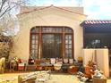 Front exterior featuring an arched window, potted plants and showcasing the home's classic architectural details at 717 W Lynwood St, Phoenix, AZ 85007
