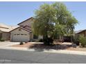 Charming two-story home features a spacious two-car garage and desert landscaping in the front yard at 723 W Milada Dr, Phoenix, AZ 85041