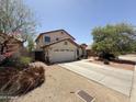 Charming two-story home features a spacious two-car garage and desert landscaping in the front yard at 723 W Milada Dr, Phoenix, AZ 85041
