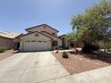 Charming two-story home features a spacious two-car garage and a desert landscaped front yard at 723 W Milada Dr, Phoenix, AZ 85041