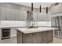 Bright kitchen featuring a large island with a white countertop and modern gray cabinetry at 7525 E Gainey Ranch Rd # 118, Scottsdale, AZ 85258