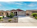 Charming single-story home with desert landscaping, covered porch and wide driveway at 7618 S Lone Pine Pl, Gold Canyon, AZ 85118