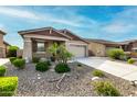 Inviting single-story home featuring desert landscaping, a covered porch, and a two-car garage at 7618 S Lone Pine Pl, Gold Canyon, AZ 85118