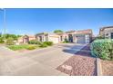 Charming single-story home with a well-maintained lawn, three-car garage, and extended driveway at 853 E Ivanhoe Ct, Gilbert, AZ 85295
