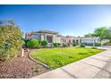 Well-manicured lawn and desert landscaping add curb appeal to this charming single-story home at 853 E Ivanhoe Ct, Gilbert, AZ 85295
