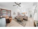 Bright living room with hardwood floors, comfortable seating, and view into the kitchen at 910 S Crossbow Ct, Chandler, AZ 85225