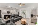 Open-concept living room with modern furnishings and a view to the gourmet kitchen at 9312 E Spiral Ave, Mesa, AZ 85212