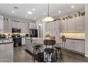 Modern kitchen with stainless steel appliances, large island with seating, and stylish light wood cabinets at 10359 E Los Lagos Vista Ave, Mesa, AZ 85209