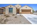 Inviting single-level home featuring a classic design, a two-car garage, and low-maintenance desert landscaping at 10548 W Crown King Rd, Tolleson, AZ 85353