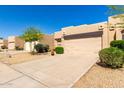 Inviting one-story home with desert landscaping, two-car garage and a cozy front entrance at 10863 N 117Th Pl, Scottsdale, AZ 85259