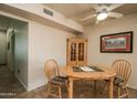 Cozy dining area features a round table with wood chairs at 11141 W Cameo Dr, Sun City, AZ 85351