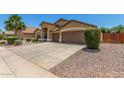 Spacious driveway leading to a charming home with well-maintained landscaping at 11303 E Pratt Ave, Mesa, AZ 85212