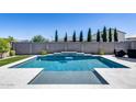 Inviting in-ground pool features a tranquil water feature, a modern design, and an expansive backyard at 13171 W Redstone Dr, Peoria, AZ 85383