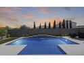 Backyard pool with waterfall feature and artificial grass, great for outdoor entertaining at 13171 W Redstone Dr, Peoria, AZ 85383
