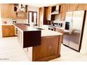 Modern kitchen with stainless steel appliances and custom wood cabinetry at 133 W Balboa Dr, Tempe, AZ 85282