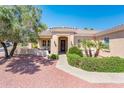 Inviting desert-landscaped home entrance with a cozy covered patio and warm curb appeal at 13444 W Cabrillo Dr, Sun City West, AZ 85375