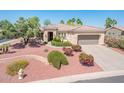 Charming single-story home with a well-manicured, colorful desert landscape and a two-car garage at 13444 W Cabrillo Dr, Sun City West, AZ 85375