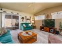 Comfortable living room with ceiling fan, sliding glass door access to patio, and entertainment center at 1640 E Augusta Ave, Chandler, AZ 85249