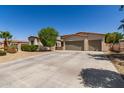 Charming home featuring a desert landscape, a three-car garage and a lush tree providing shade at 1804 W Magdalena Ln, Phoenix, AZ 85041