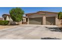 Charming home featuring a desert landscape, a three-car garage and a lush tree providing shade at 1804 W Magdalena Ln, Phoenix, AZ 85041