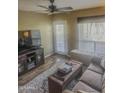 Comfortable living room features a ceiling fan, a plush sofa, and natural light, highlighting a relaxing space at 1825 W Ray Rd # 1134, Chandler, AZ 85224