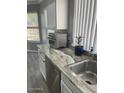 Bright kitchen with white cabinets, stainless steel sink, and granite countertop at 19014 N 91St Dr, Peoria, AZ 85382