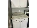 Bright kitchen with granite countertop and white cabinets at 19014 N 91St Dr, Peoria, AZ 85382
