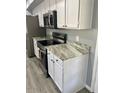 Modern kitchen with stainless steel appliances, granite countertops and white cabinets at 19014 N 91St Dr, Peoria, AZ 85382