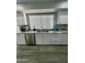 Bright kitchen with granite countertop and white cabinets at 19014 N 91St Dr, Peoria, AZ 85382