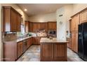 Well-equipped kitchen features custom cabinets, granite countertops, a center island, and stainless appliances at 1922 E Everett Dr, Phoenix, AZ 85022
