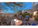 Cozy outdoor patio featuring a stone fire pit and comfortable seating area at 19475 N Grayhawk Dr # 1039, Scottsdale, AZ 85255