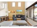Inviting living room with a fireplace, hardwood floors, neutral walls, and oversized window at 19475 N Grayhawk Dr # 1115, Scottsdale, AZ 85255