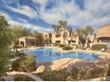 Community pool featuring a pergola, mature landscaping, and ample seating at 19475 N Grayhawk Dr # 1115, Scottsdale, AZ 85255
