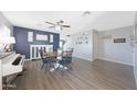 Dining room with modern decor, including a dining table set, piano, and stylish lighting fixtures at 21754 W Pima St, Buckeye, AZ 85326