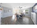 Bright dining area featuring wood-look floors, a round table, and a view of the front yard at 21754 W Pima St, Buckeye, AZ 85326