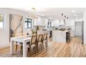 Open floor plan showcases kitchen with a waterfall island, stainless appliances, and a dining area with a chandelier at 2353 N 51St Pl, Phoenix, AZ 85008