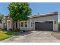 Attractive single-story home featuring a two car garage, stone accents, and a green front lawn at 24350 S 208Th Pl, Queen Creek, AZ 85142